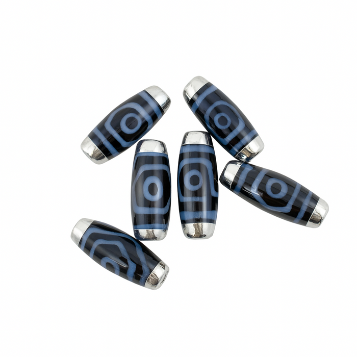 Blue and silver cylindrical beads on a white background